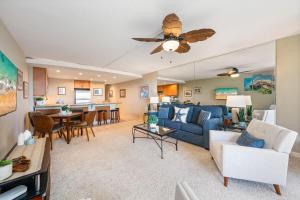 a living room with a blue couch and a table at Kahana Villa F405 · KV F405 Perfect Maui Getaway Condo w Ocean V in Kahana
