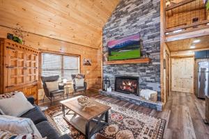 a living room with a fireplace in a log cabin at Luxury Cabin with Hot Tub and Resort Access in Sevierville