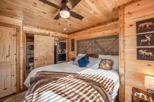 a bedroom with a bed in a log cabin at Luxury Cabin with Hot Tub and Resort Access in Sevierville