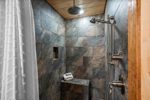 a bathroom with a shower with a shower curtain at Luxury Cabin with Hot Tub and Resort Access in Sevierville