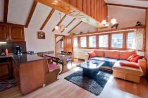 a living room with a couch and a table at Furggen, Chalet Museum in Grächen