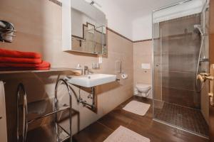 a bathroom with a sink and a shower at Ferienwohnungen Rupertihaus in Flachau