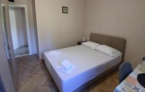 Un dormitorio con una cama con dos toallas encima. en Amazing Apartment In Janjina With Lake View, en Drače