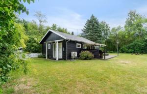 a small black house with a yard at 2 Bedroom Awesome Home In Hasle in Hasle +8 photos