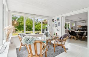 a living room with a table and chairs at 2 Bedroom Awesome Home In Hasle in Hasle