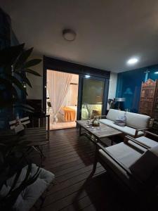 a living room with a couch and a table at Suite apartaments in Gibraltar