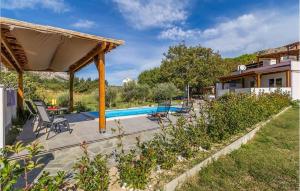 a villa with a swimming pool and a house at Cozy Apartment In Baska With Swimming Pool in Draga Bašćanska