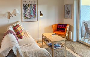 a living room with a couch and a chair at Awesome Apartment In Hals With House A Panoramic View in Skovsgård