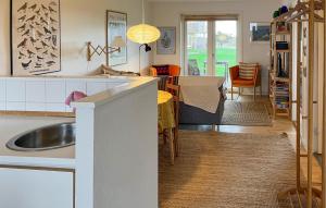 a kitchen with a sink and a dining room at Awesome Apartment In Hals With House A Panoramic View in Skovsgård +9 photos
