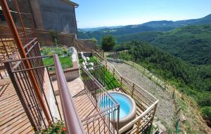 a balcony with a tub on the side of a house at Lovely Home In Castelletta in Precicchie