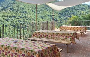 two beds on a balcony with mountains in the background at Lovely Home In Castelletta in Precicchie