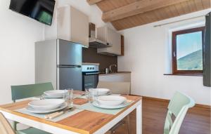 a kitchen with a wooden table with plates on it at Lovely Home In Castelletta in Precicchie