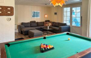 a living room with a pool table at Lovely Home In Væggerløse With Sauna in Marielyst