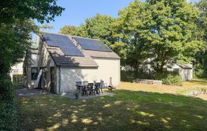 a house with solar panels on the roof at Cozy Home In Hoeven With Wifi in Hoeven