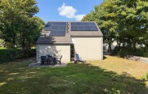 a small house with solar panels on the roof at Cozy Home In Hoeven With Wifi in Hoeven +2 photos