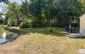a yard with a table and chairs and a vase at Cozy Home In Hoeven With Wifi in Hoeven