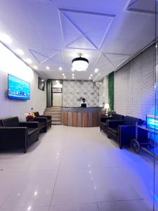 a large waiting room with couches and a bar at Park View Hotel Gulberg in Lahore