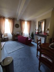 a living room with a red couch and a fireplace at Appartement T3 2 chambres - 6 personnes in Luz-Saint-Sauveur +10 photos