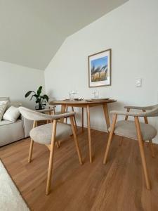a living room with two tables and a couch at Ferienwohnung-Pappelhof in Dannau