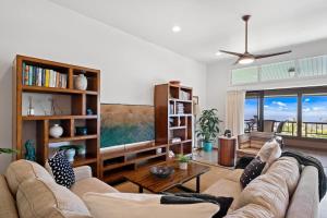 a living room with a couch and a large window at Kapalua Ridge Villas 1023 in Kahana