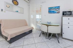 a living room with a chair and a table at House Osti in Rogoznica