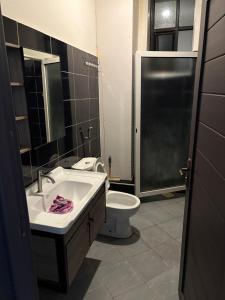 a bathroom with a sink and a toilet at Trustbridge in Kampala