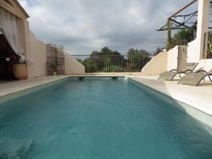 a swimming pool with blue water in a house at Villa couleurs du sud in Bize-Minervois +11 photos