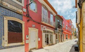 a red building on the side of a street at Casa Bauínia in Setúbal