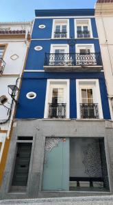 a blue and white building with windows and balconies at AL-Andalus in Elvas