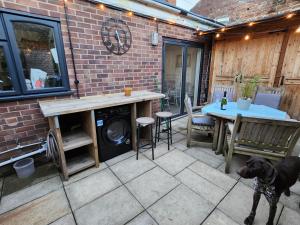a dog on a leash standing on a patio at AnchorageWells Entire Cottage in Wells next the Sea
