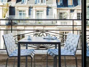 a table and two chairs sitting on a balcony at Sofitel Paris Arc De Triomphe in Paris