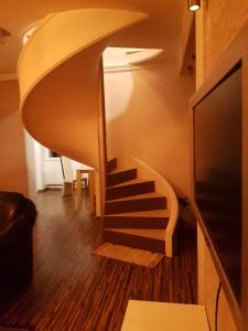 a spiral staircase in a room with wooden floors at Villa BS Sarajevo in Sarajevo