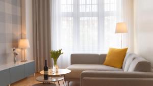 a living room with a couch and a window at Carl.22 City Appartements in Eisenach