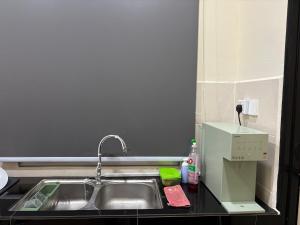 a kitchen counter with a sink and a mixer at Arora Homestay in Marang +12 photos