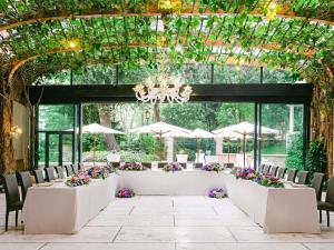 a wedding set up in a conservatory with tables and chairs at Papadopoli Hotel Venezia - MGallery Collection in Venice