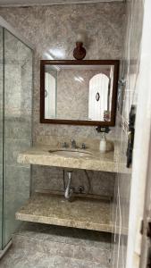 a bathroom with a sink and a mirror at Casa Ohana - Miguel Pereira in Miguel Pereira