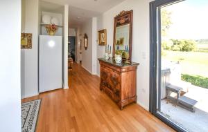a living room with a large window and a wooden floor at Maison Avec Piscine Et Jacuzzi in Allex