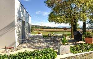 a patio with a table and chairs next to a building at Maison Avec Piscine Et Jacuzzi in Allex +12 photos