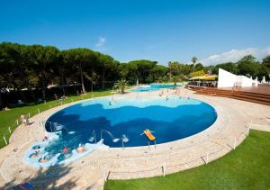 eine Draufsicht auf einen großen Swimmingpool mit Menschen darin in der Unterkunft Happy Camp mobile homes in Villaggio Camping Baia Domizia in Baia Domizia