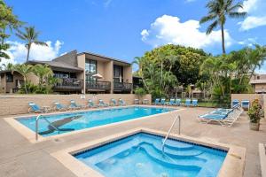 a swimming pool with lounge chairs and a resort at Kihei Garden Estates G207 · KGE G207 Newly Updated 2BD Condo AC in Kihei