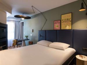 a bedroom with a large white bed in a room at ibis Cannes Centre in Cannes +61 photos