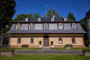 a large brick house with a gray roof at Schloss Hotel Alte Rentkammer in Birstein