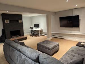 a living room with a couch and a fireplace at Atlantic Oasis in Halifax