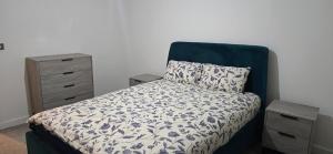 a bedroom with a bed with a pillow and a dresser at Cozy Broad Street Apartment Central and Comfortable in Birmingham