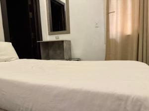 Ένα ή περισσότερα κρεβάτια σε δωμάτιο στο Veda hotel