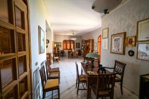 a dining room with a table and chairs at Il Rifugio del Templare in Roccavaldina +30 photos