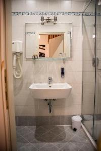 a bathroom with a sink and a mirror and a toilet at Locanda Ca' Lucrezia in Venice