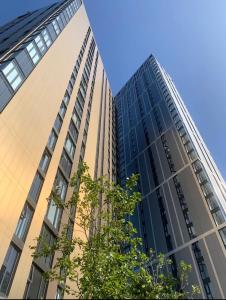 two tall buildings next to each other at Cozy Broad Street Apartment Central and Comfortable in Birmingham