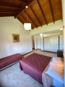 a bedroom with two beds and a projection screen at Complejo Abuela Lety in Merlo