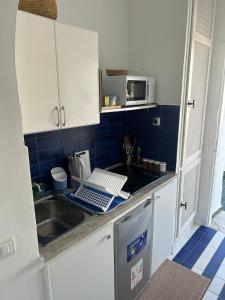 a small kitchen with a sink and a microwave at Charmant Studio Port El Kantaoui in Hammam Sousse +16 photos